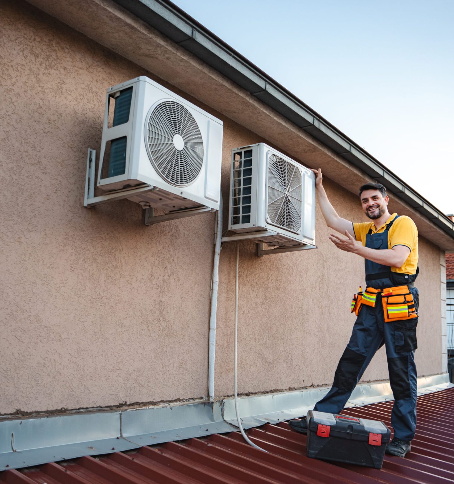 HVAC technician is installing an air conditioner on a building rooftop